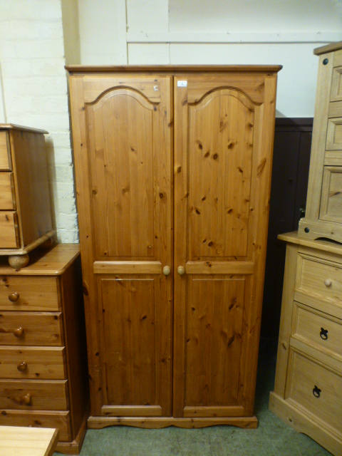 A modern pine two door wardrobe