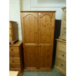 A modern pine two door wardrobe