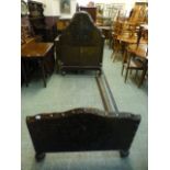 A Spanish style bedstead having an embossed brown leather head and foot