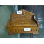A mid-20th century carved music box in the form of a settle CONDITION REPORT: H.
