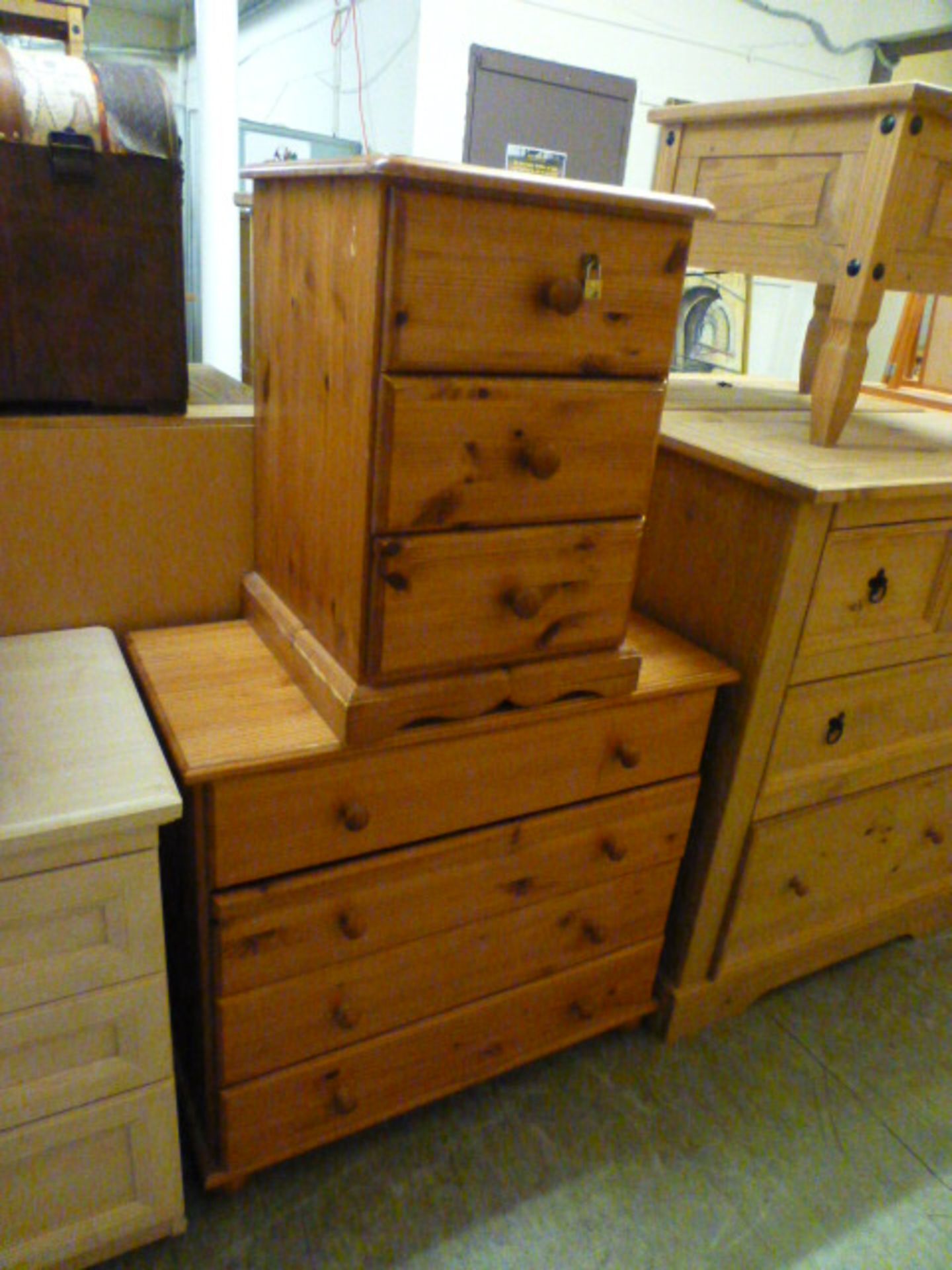 A pine chest of four long drawers along with a pine bedside chest