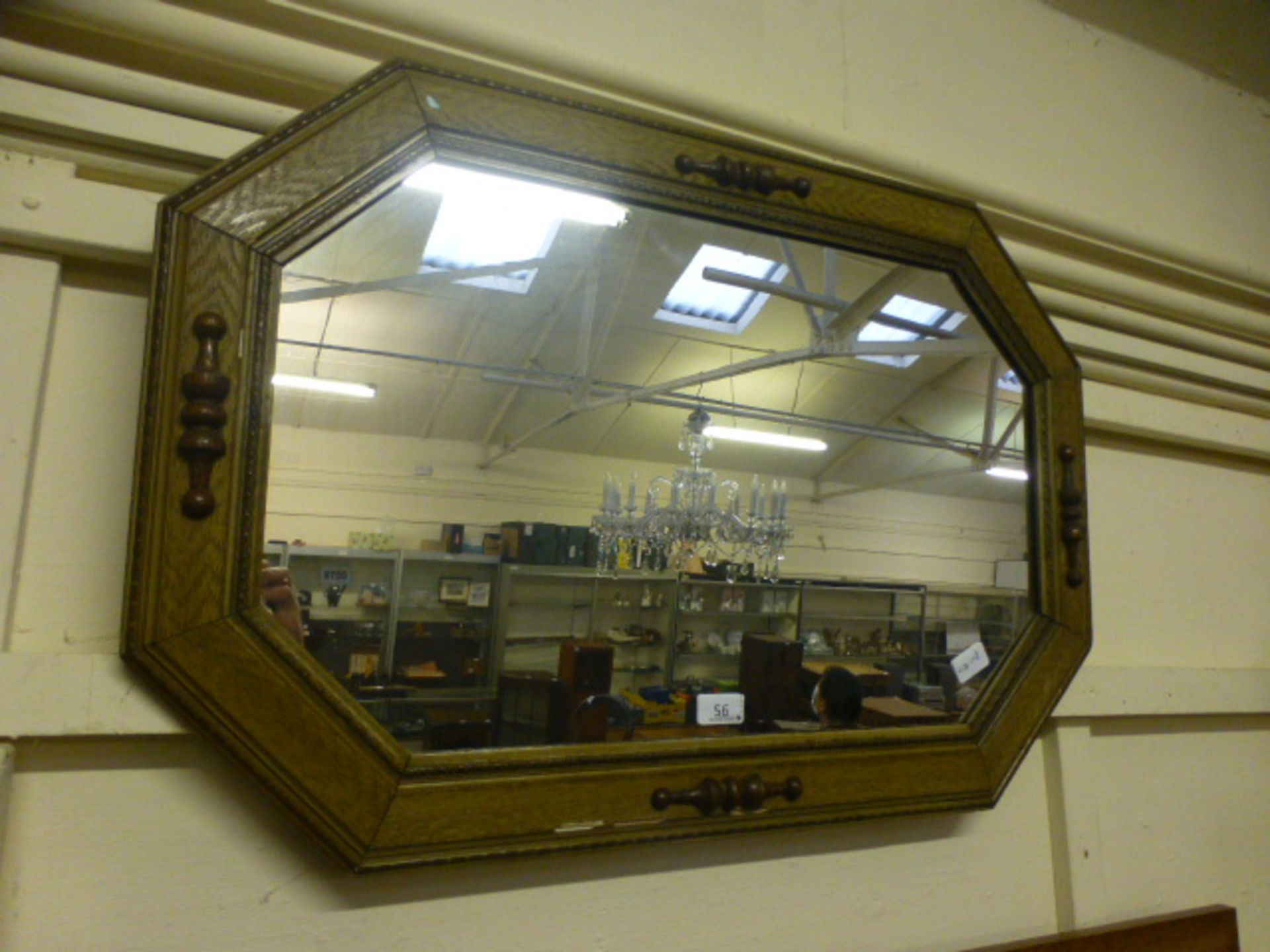 A reproduction wood effect wall mirror