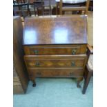 A mid-20th century walnut veneered fall front bureau