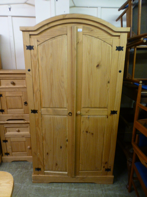 A pine two door arch topped wardrobe