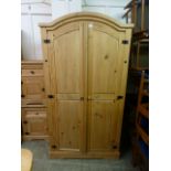 A pine two door arch topped wardrobe