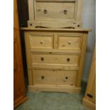 A stripped pine chest of two short over two long drawers