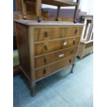 A mid 20th century walnut chest of four long drawers A/F