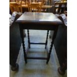 A mid-20th century oak occasional table with barley twist supports