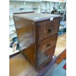 A mid-20th century oak three drawer bedside cabinet