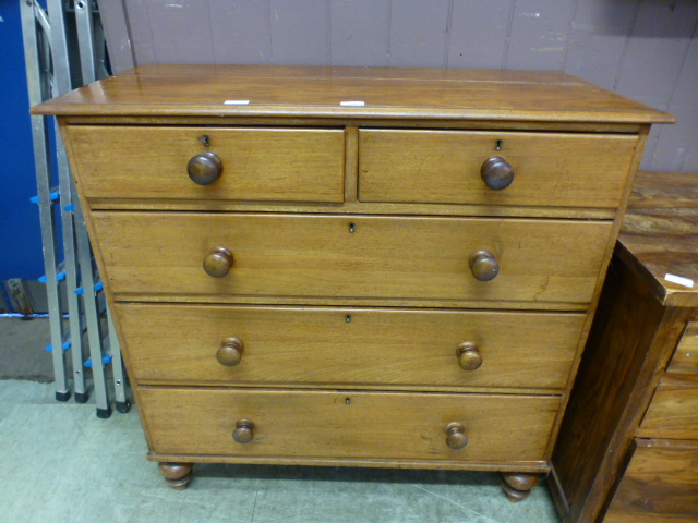 A Victorian mahogany chest of two short over three long drawers with turned handles