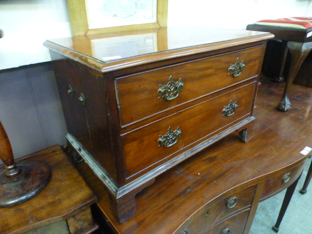 A Georgian style mahogany chest of two drawers on bracket feet