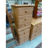 A pair of modern pine three drawer bedside chests