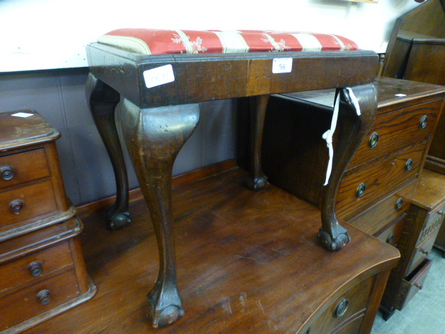 An 18th century style walnut stool on cabriole legs with ball and claw feet