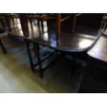 A mid 20th century oak gate leg table with barley twist supports