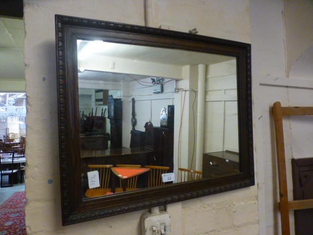 An early 20th century oak framed mirror