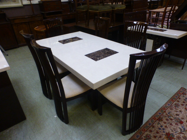 An Italian style marble dining table with contrasting marbles along with a set of six stained ash