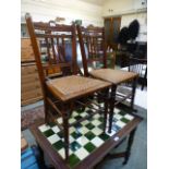 A pair of Edwardian walnut framed bedroom chairs with bergere seats