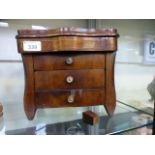 A rosewood veneered miniature chest