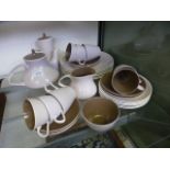 A two tone brown Poole part table set comprising of tea pot coffee pot, cups,