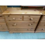 A modern pine chest of two short over two long drawers