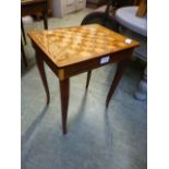 A small musical lift up lid games table with chess pieces