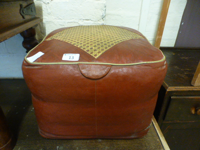 A red leather pouffe