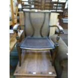 An early 20th century beech and bergere open arm chair