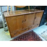 An Ercol sideboard having three drawers above two doors