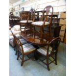 A reproduction cherry wood effect extending dining table with a set of six (2+4) matching chairs