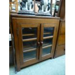 An early 20th century oak book case with two glazed doors