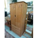 A modern pine two door wardrobe with three drawers to base