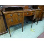 A George III mahogany and boxwood strung serpentine front sideboard,