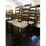 A set of four 19th century oak ladder back chairs with seagrass seats