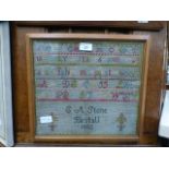 A framed and glazed sampler dated 1882