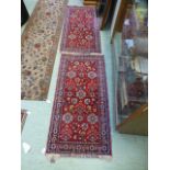A pair of small red ground rectangular rugs