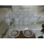 A selection of glassware comprising of twelve cut drinking glasses and two cut glass trinket bowls