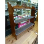 An Edwardian mahogany wall mounted three tier shelf unit