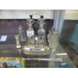 A silver hallmarked stand containing two blue glass bottles and two others together with a