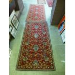A pair of red ground rugs