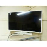 A JVC flat screen TV with remote