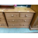 A modern pine chest of two short over two long drawers