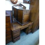 A mid 20th century oak bedside cabinet along with a matching dressing table