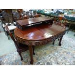 A Chinese padouk extending table with two leaves along with a set of four matching chairs with