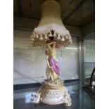 A ceramic table lamp in the form of ladies