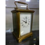 A brass and glass carriage clock