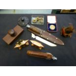 A box containing an assortment of collectibles to include two miniature desktop anvils,