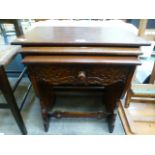 A reproduction oak nest of three tables,