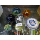 Seven glass paperweights