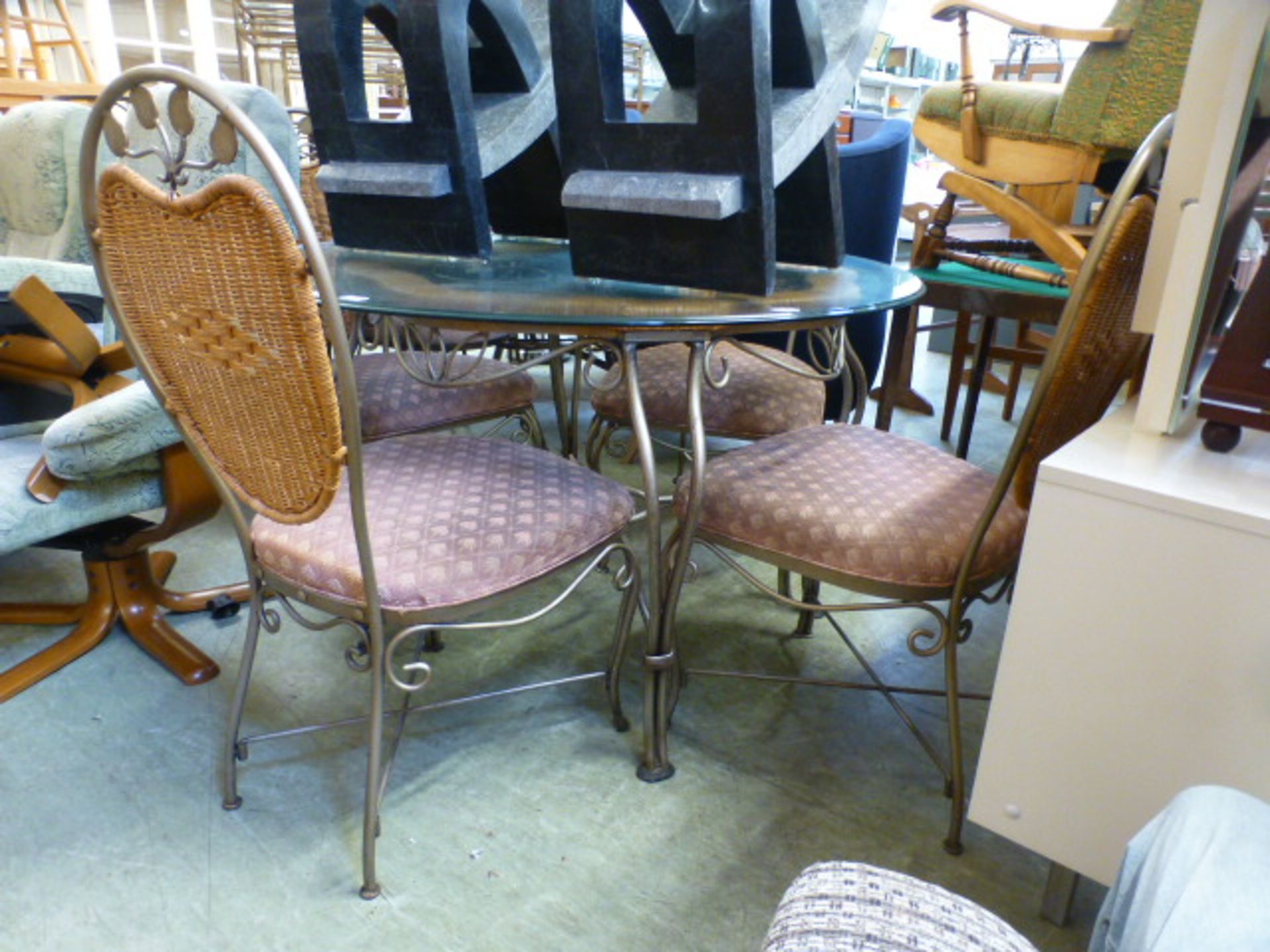 A modern circular metalwork based conservatory table with a set of four matching chairs