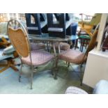 A modern circular metalwork based conservatory table with a set of four matching chairs